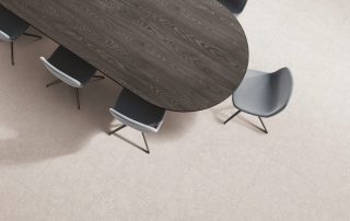 Top view of business room interior with black wooden table and chairs, carpet on grey concrete floor. Cozy conference space with minimalist furniture and sideboard. 3D rendering